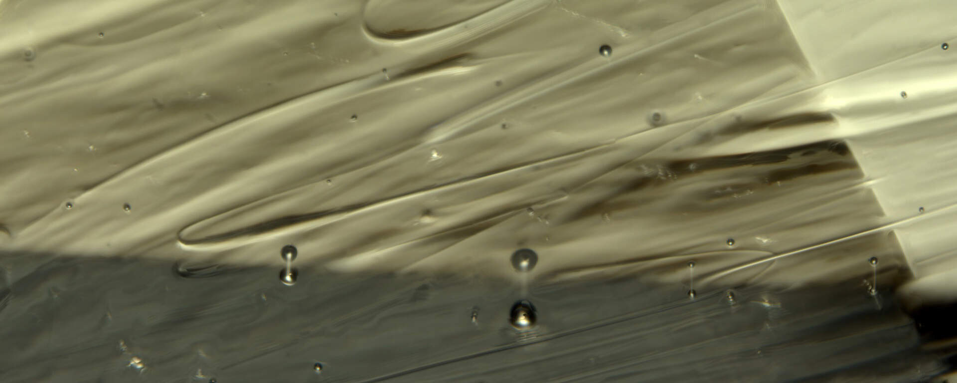 Bubbles and swirls in moldavite (natural glass)