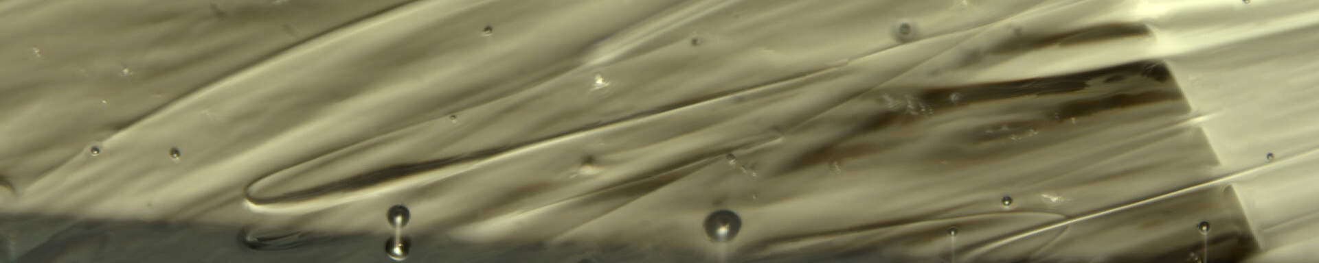 Bubbles and swirls in moldavite (natural glass)